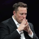 Musk’s $10B Promise – But To Which Kids? Elon Musk seated with hands steepled in thought