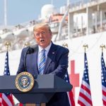 Trump’s Diesel Shock: Tax Bill Vanishes Donald Trump speaking at a podium with American flags and a ship in the background