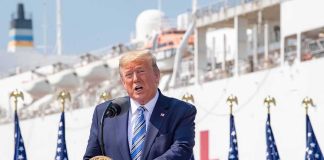 Trump’s Diesel Shock: Tax Bill Vanishes Donald Trump speaking at a podium with American flags and a ship in the background