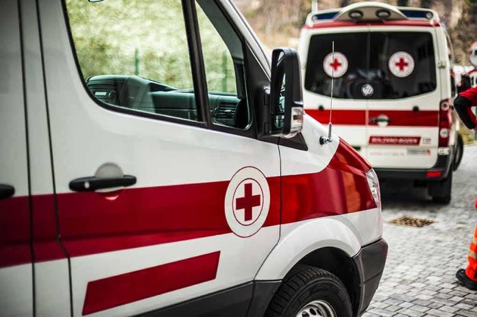 shutterstock_376480093 Ambulances with red cross markings parked on a cobblestone street