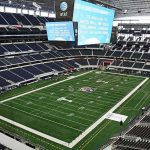 Tragedy Above: Airman Falls At Alamodome American football stadium interior with large central video board