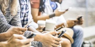 Group of people sitting and using smartphones